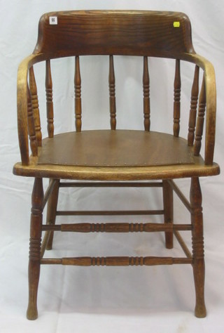 An elm tub back open arm chair with spindle turned back, on turned supports