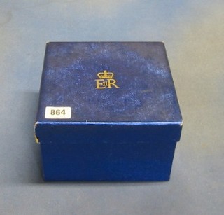 A square cardboard box covered in garter blue paper and having Elizabeth II Royal Cypher 7 1/2"