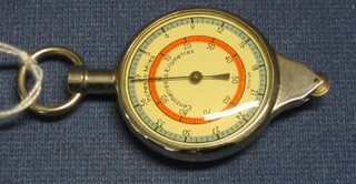 A stainless steel cased compass/mileometer