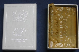 A presentation slice of HRH The Prince of Wales and Lady Diana Spencer's wedding cake, contained in a presentation cardboard package, with C D Cypher, Buckingham Palace 29th July 1981, 4 1/2" x 3 1/2" together with a card "Best Wishes from their Royal Highness The Prince and Princess of Wales"  