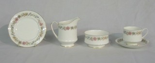 A Paragon 18 piece Belinda pattern tea service (a gift from HM The Queen) comprising: circular twin handled bread and butter plated, 6 tea plates, 6 saucers, 3 tea cups (1 chipped), sugar bowl and cream jug