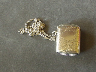 An Edwardian silver vesta case with engraved decoration Birmingham 1902 hung on a silver chain