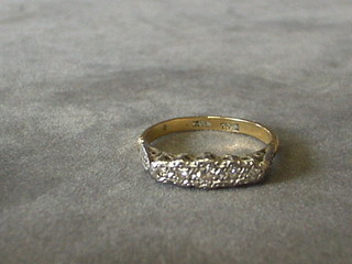 A lady's gold dress ring set 3 illusion set diamonds