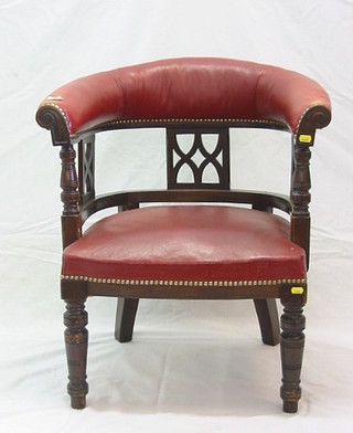 A late Victorian mahogany framed tub back chair upholstered red rexine, on turned supports