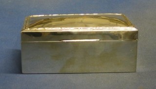 A rectangular silver cigarette box with hinged lid Birmingham 1923, the lid engraved but rubbed, 7"
