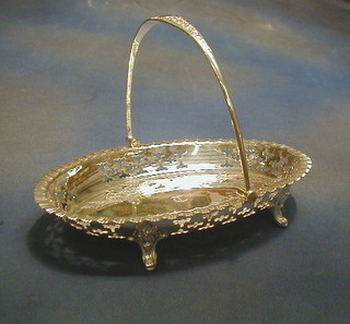 A silver plated cake basket with swing handle and engraved decoration