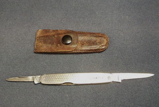 A silver pen knife contained in a leather case