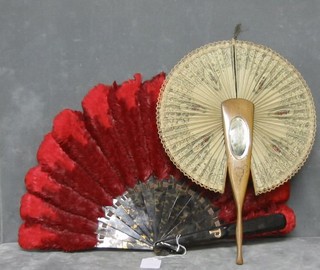 A tortoiseshell and red ostrich feather fan and an olive wood fan