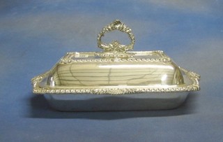 A rectangular silver plated entree dish and cover and a condiment set