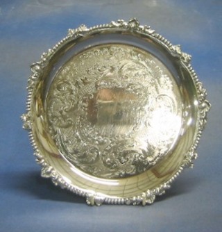 A circular silver plated salver with bead work border and engraved decoration