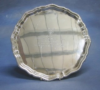 A modern silver salver with bracketed border, raised on bun feet inscribed "Presented to Morris Collinson MA on the completion of 40 years service as Clerk to the Worshipful Company of Bakers 1936 - 1976" 12", 45 ozs Sheffield 1976?