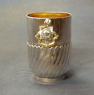 A Victorian silver tankard with swirled demi-reeded decoration, London 1894 and applied with a Royal Sussex Regiment cap badge 6 ozs