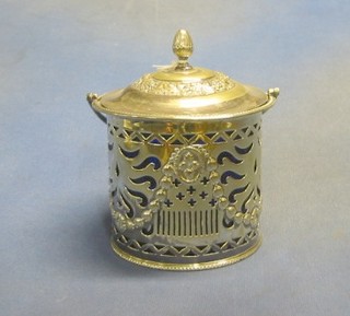 A circular pierced silver plated biscuit barrel with blue glass liner and swing handle 5"