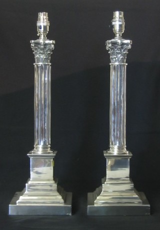 A pair of large and impressive modern silver plated Corinthian column table lamps