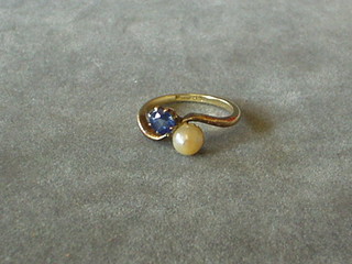 A lady's 18ct gold dress ring set a blue stone and a simulated pearl