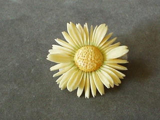 An ivory brooch in the form of a flower head