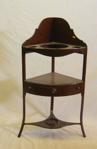 A Georgian mahogany corner wash stand with raised back fitted 3 bowl recepticals, the base fitted a drawer, raised on outswept supports 21"