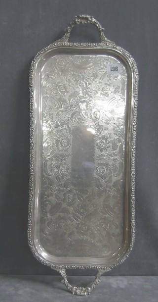 A rectangular silver plated bottle tray with engraved decoration