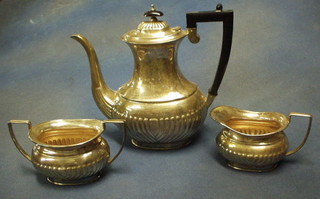 A silver plated 3 piece coffee service with demi-reeded decoration with coffee pot, twin handled sugar bowl and cream jug