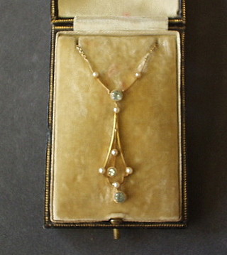 A lady's Edwardian 18ct gold pendant set aquamarine and pearls hung on a fine gold chain