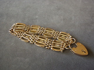 A 14ct hollow gold gate link bracelet with padlock clasp,