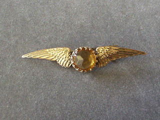 A lady's 9ct gold winged bar brooch set a yellow stone