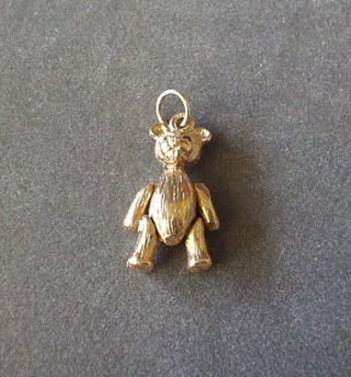 A gold figure of a teddybear with articulated limbs