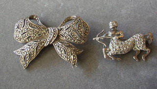 A marcasite bow brooch and 1 other