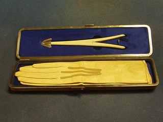 A Victorian leather and polished metal glove case fitted a pair of kid gloves and a glove stretcher