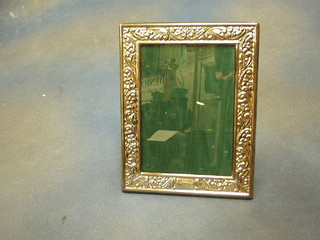 An embossed silver plated easel photograph frame