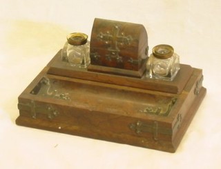 A Victorian rectangular figured walnutwood standish with pen tray, fitted arched nib box flanked by a pair of cut glass inkwells, 12"