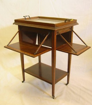 An Edwardian inlaid and crossbanded mahogany rectangular 4 tier drop flap servery, the upper section with trays, the sides fitted 4 drop tiers, the base having an undertier, 21"