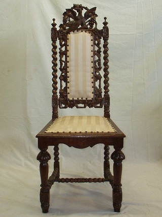 A pair of Victorian carved oak Carolean style dining chairs, the cresting rails carved birds