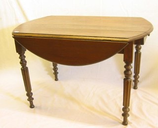 A French elm drop flap dining table, raised on tuned and reeded supports