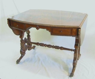 A 19th/20th Century Continental figured mahogany sofa table, fitted 2 drawers, raised on turned supports united by an H framed stretcher 63"