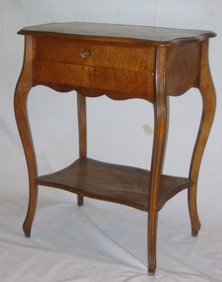 A French walnutwood sewing table with hinged lid, fitted an undertier and raised on cabriole supports 22"