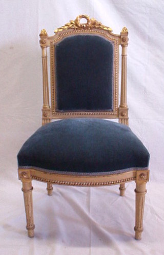 A pair of French Empire style chairs with upholstered seats and backs, on turned and reeded supports