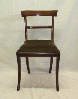 A set of 4 Georgian mahogany bar back dining chairs with plain midrails, on sabre supports,