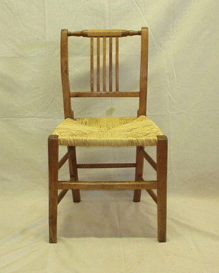 A pair of 19th Century bleached fruitwood stick and rail back chairs with woven rush seats