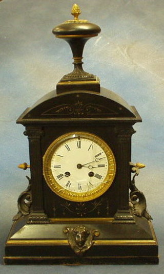 A Victorian French 8 day striking mantel clock with enamelled dial, contained in black architectural case, surmounted by a lidded urn