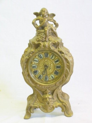 A 19th Century French 8 day mantel clock with porcelain dial contained in a gilt spelter case, surmounted by a figure of a cherub