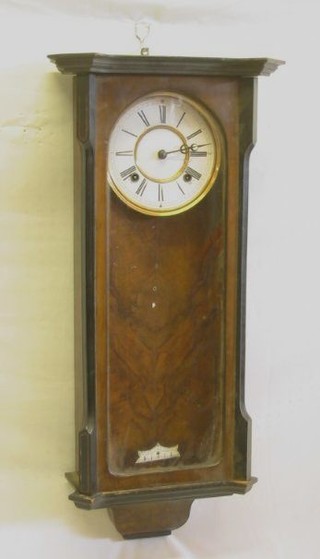 A striking Vienna style regulator with 7" porcelain dial, Roman numerals, contained in a walnutwood case