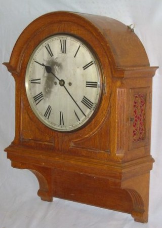 A 19th Century double fusee, striking wall clock, the 12" circular silvered dial with Roman numerals and brass bezel, contained in a honey oak arch shaped case (1 strike fusee f) 27" high x 19"