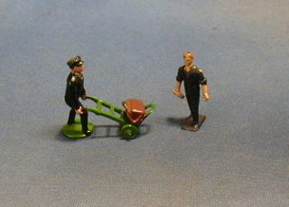 A figure of a railway porter with sackbarrow and bag and 1 other figure of an engineer