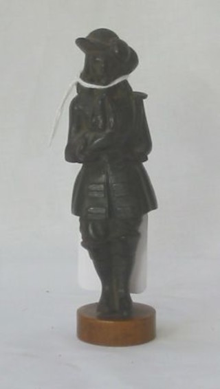 A bronze figure of a standing gentleman in 17th Century dress, 4"