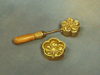 A 19th Century brass floral shaped milliner's iron