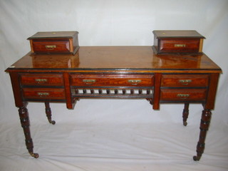 A Victorian walnutwood dressing table, fitted 2 glove boxes and 1 long and 2 short drawers, raised on turned supports 52"