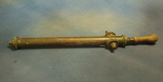 A brass garden syringe
