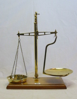 A pair of 19th Century brass scales, raised on an iron base by Frankel Bros of London, class B to weigh 12 ozs