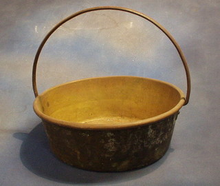 A brass preserving pan with iron handle